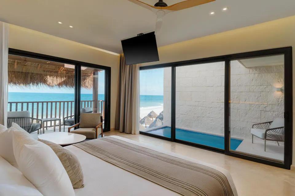 Dunas suite king bed beside a private pool terrace at Valentin Imperial Riviera Maya.