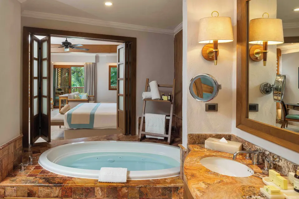 Golden Junior Suite bathroom with tub and vanity at Valentin Imperial Riviera Maya.