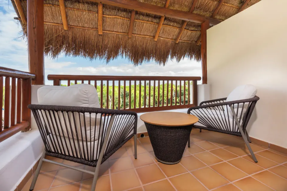 Golden Junior Suite covered balcony seating at Valentin Imperial Riviera Maya.