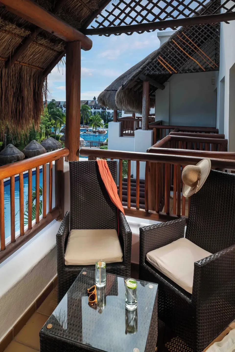 Golden Superior Junior Suite balcony seating with pool view at Valentin Imperial Riviera Maya.