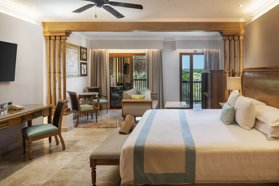 Golden Superior Junior Suite with king bed and sitting area at Valentin Imperial Riviera Maya.