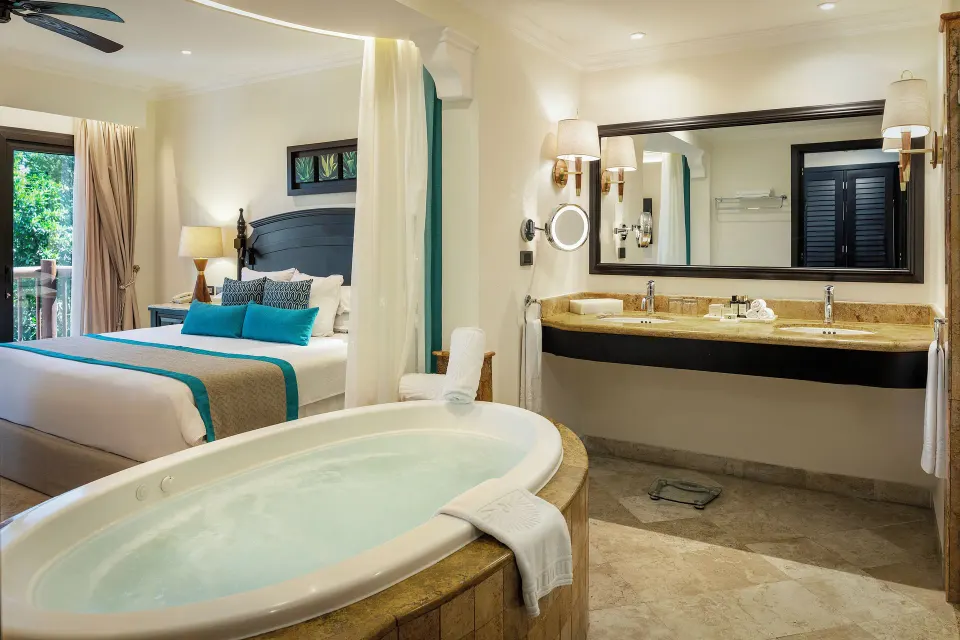 Silver Junior Suite bath and king bed at Valentin Imperial Riviera Maya.