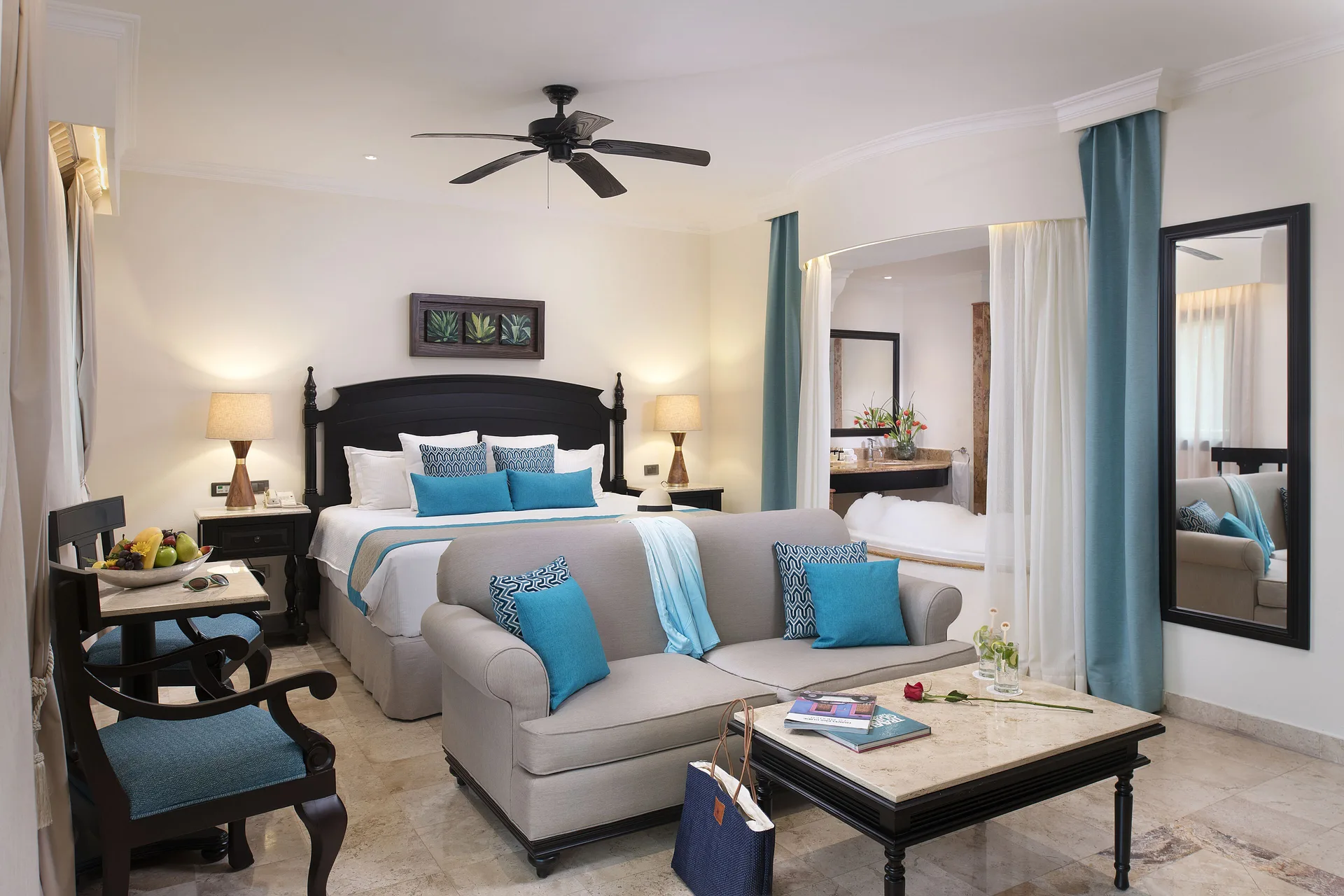 Silver Junior Suite king bed and sitting area at Valentin Imperial Riviera Maya.