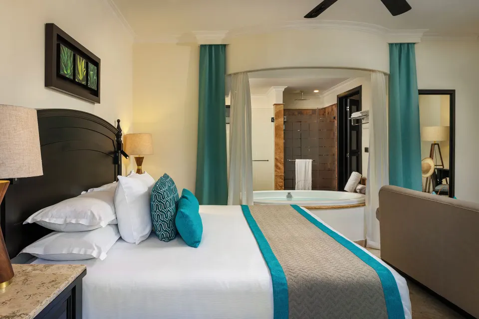 Silver Junior Suite king bed and soaking tub at Valentin Imperial Riviera Maya.