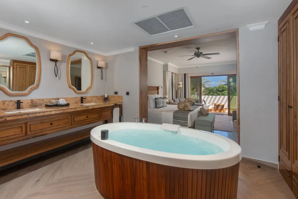 Suite Imperial Privé bath with soaking tub and bedroom view at Valentin Imperial Riviera Maya.