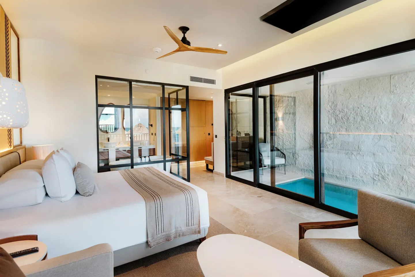 Dunas Private Pool Ocean View Suite bedroom with glass-enclosed pool at Valentin Imperial Riviera Maya.