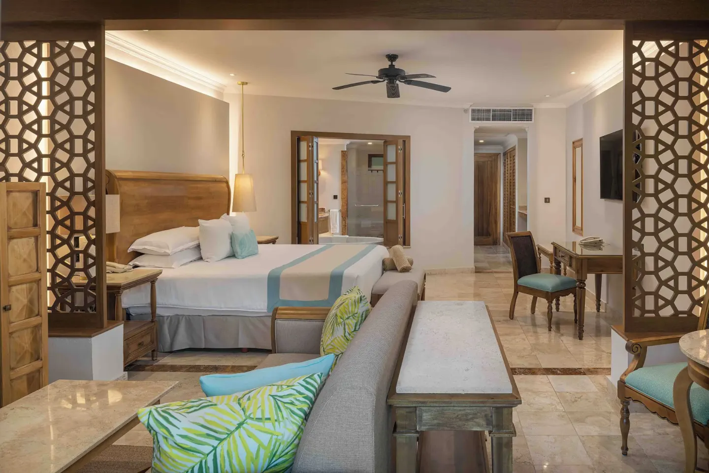 Golden Swim Up Junior Suite king bed viewed from the lounge at Valentin Imperial Riviera Maya.
