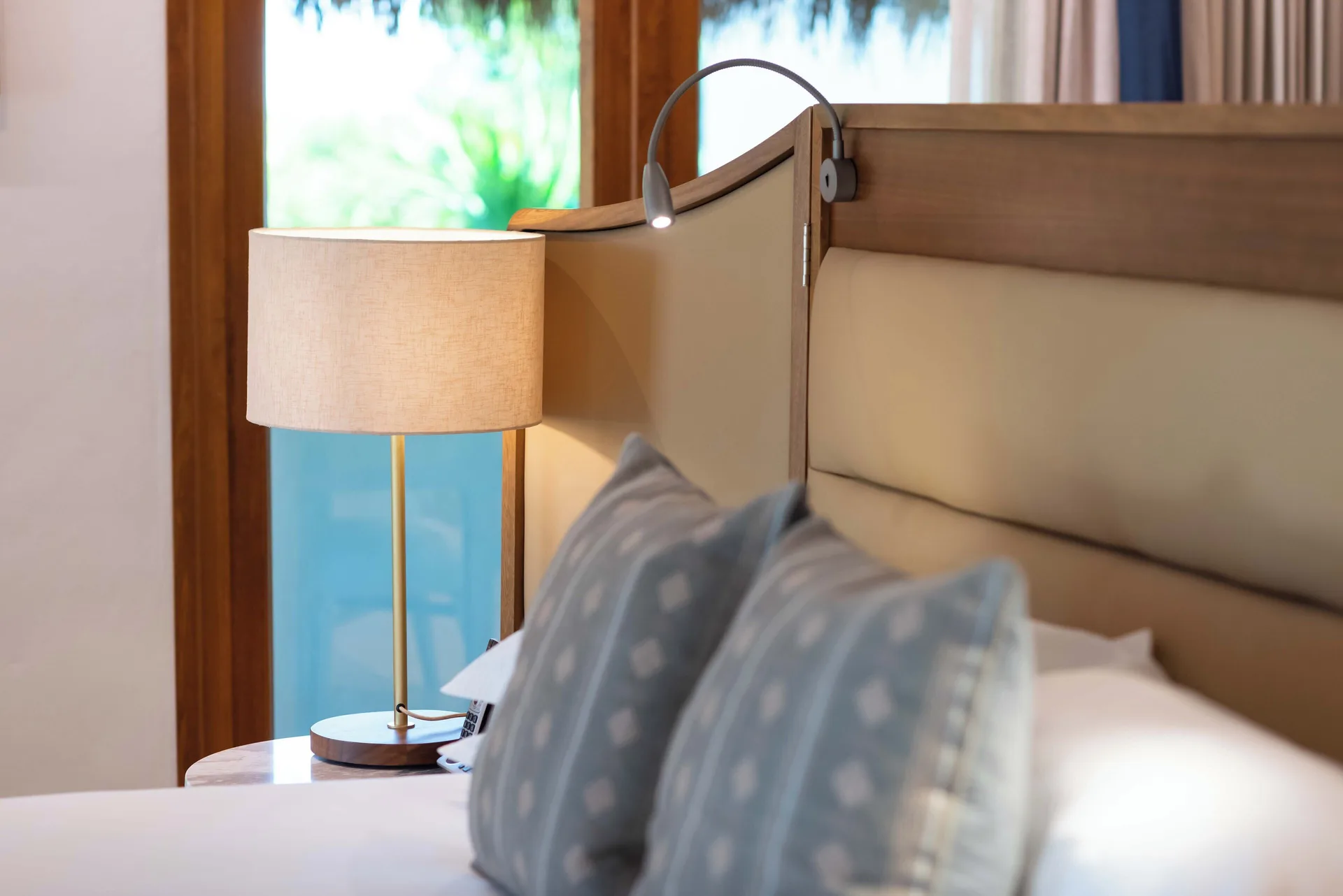 Onyx Honeymoon Suite bed with pillows and bedside lamps at Valentin Imperial Riviera Maya.