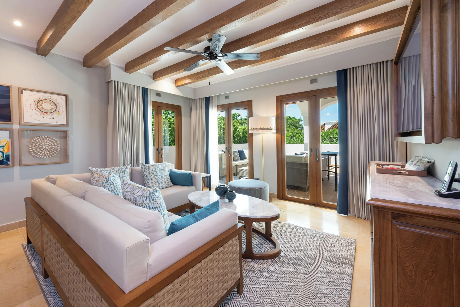 Onyx Honeymoon Suite living room with sofas and terrace doors at Valentin Imperial Riviera Maya.