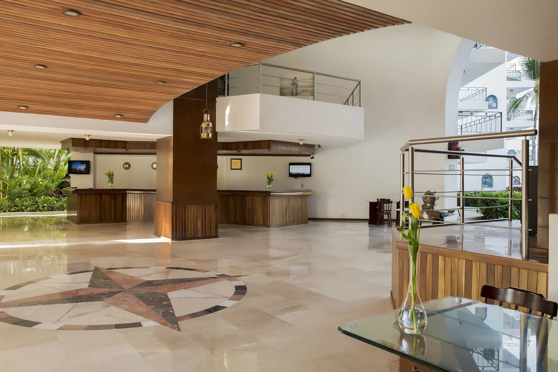 Bright lobby with reception desks at Vamar Vallarta Marina and Beach Resort.