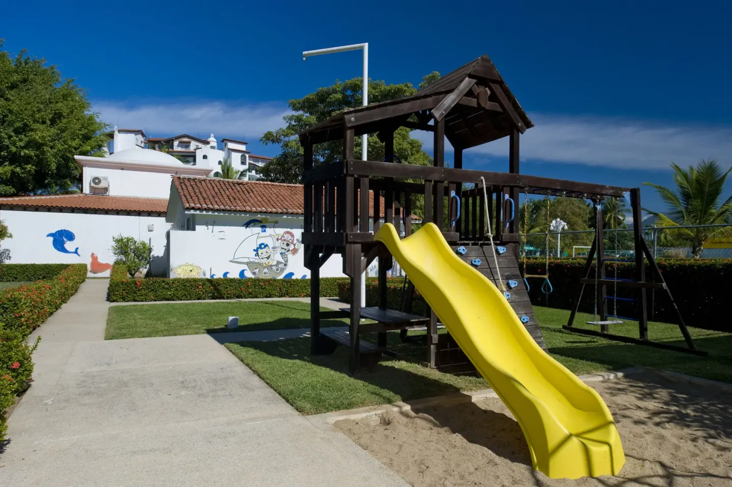 Playground with yellow slide at Vamar Vallarta Marina and Beach Resort.