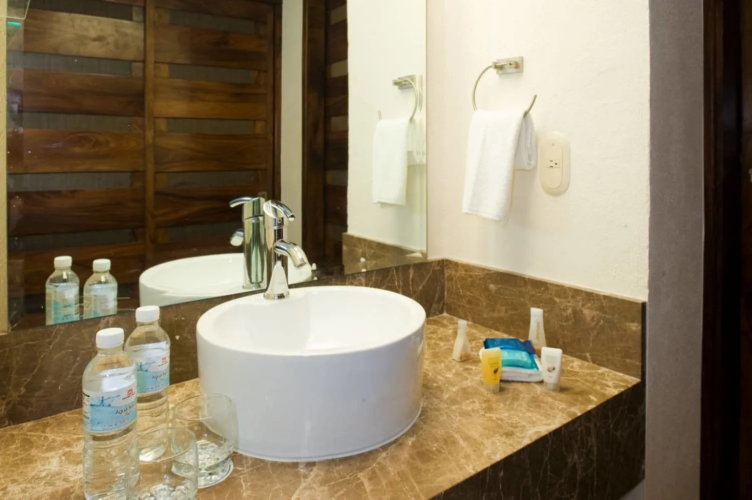 1 Bedroom Villa bathroom sink at Vamar Vallarta Marina and Beach Resort with marble counter and mirror.