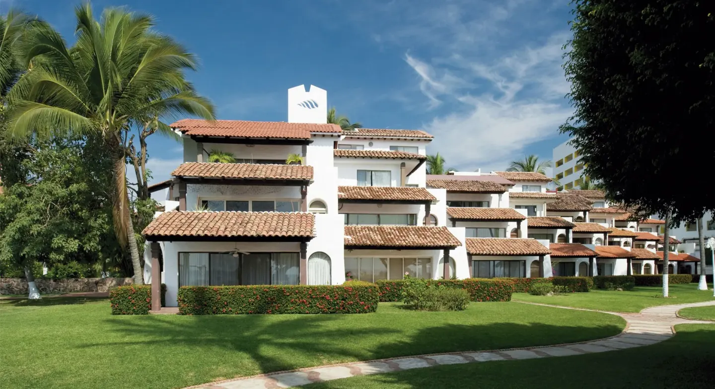 1 Bedroom Villa exterior at Vamar Vallarta Marina and Beach Resort with tile roofs and garden lawn.