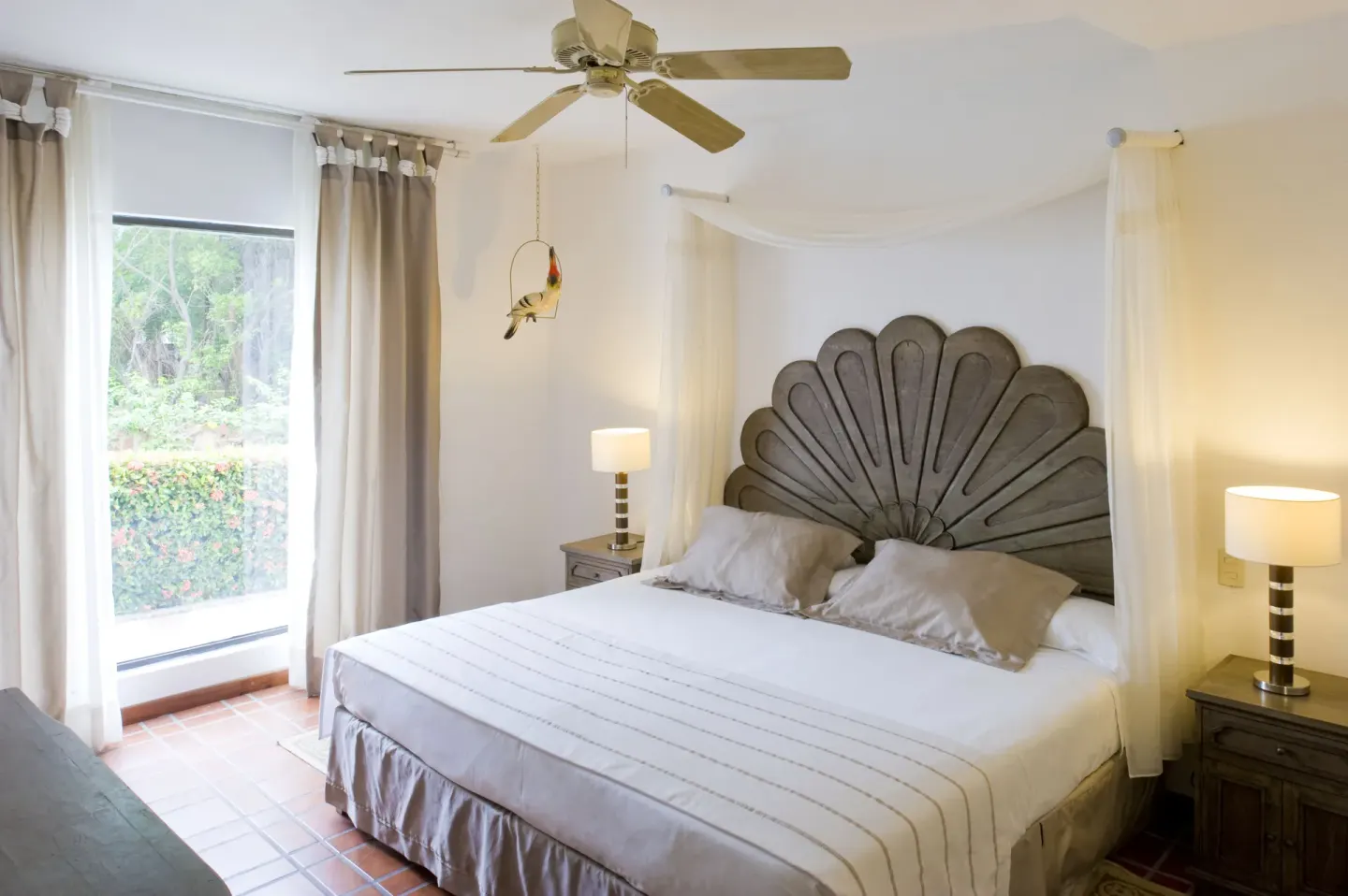 One Bedroom Villa king bed with canopy drapes at Vamar Vallarta Marina and Beach Resort.