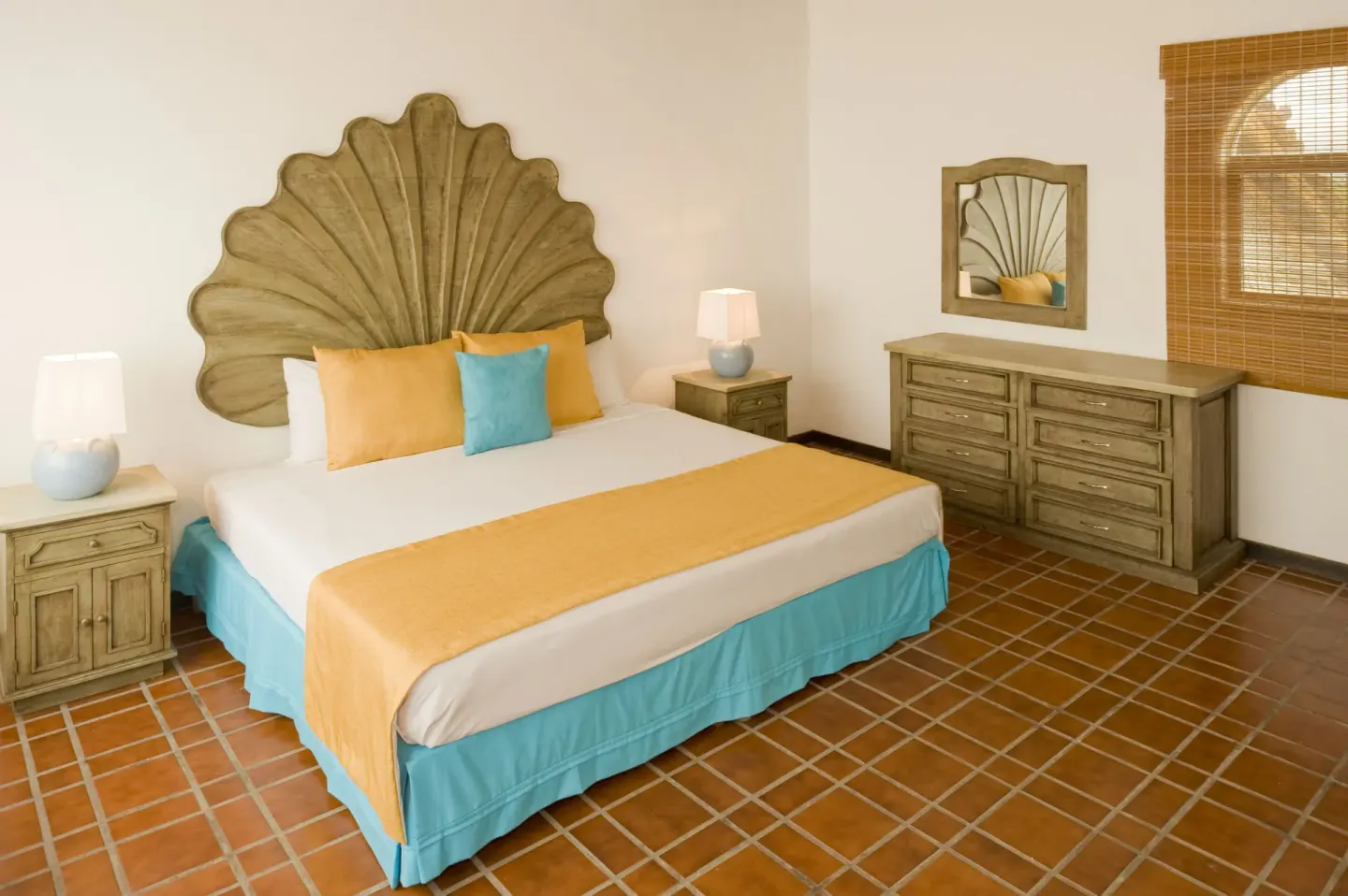 One Bedroom Villa bedroom with shell headboard at Vamar Vallarta Marina and Beach Resort.