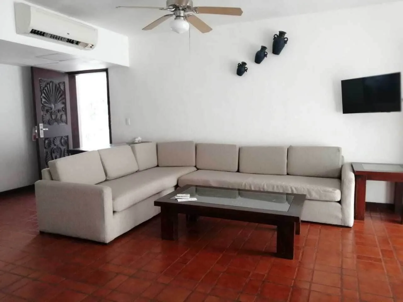 One Bedroom Villa living room with sectional sofa at Vamar Vallarta Marina and Beach Resort.