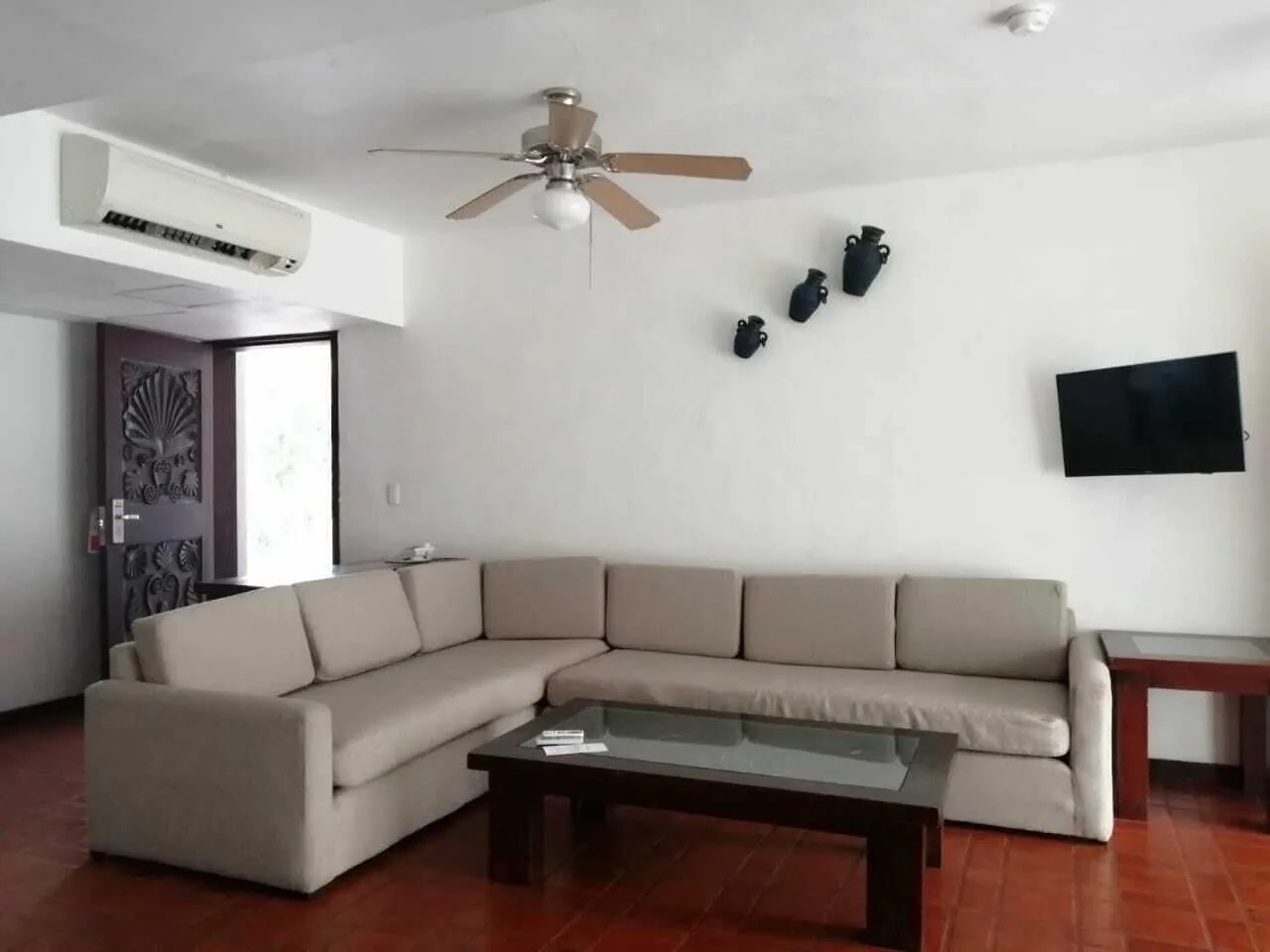 One Bedroom Villa lounge with sofa and TV at Vamar Vallarta Marina and Beach Resort.