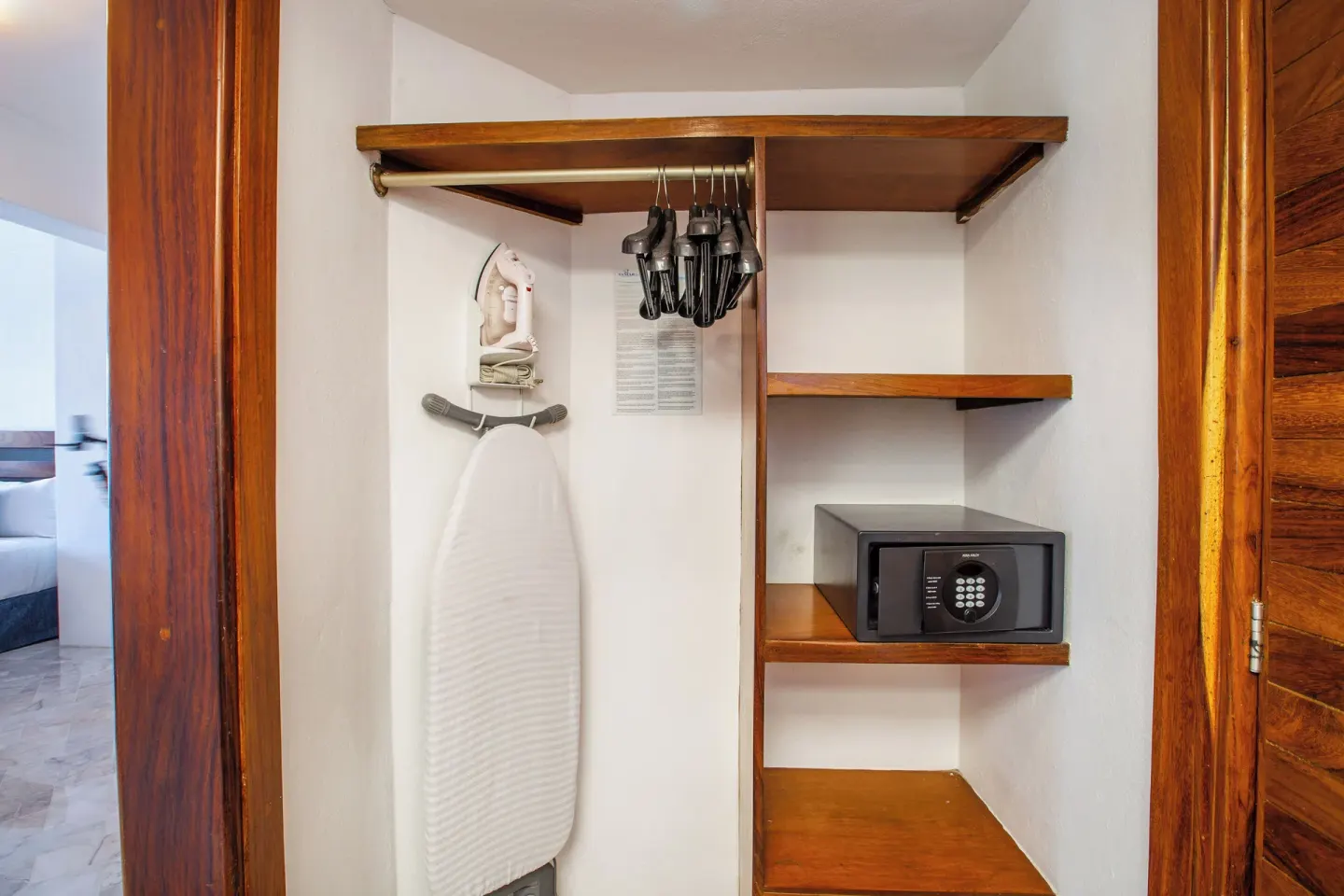 Superior Con Balcón closet with safe and ironing board at Vamar Vallarta Marina and Beach Resort.