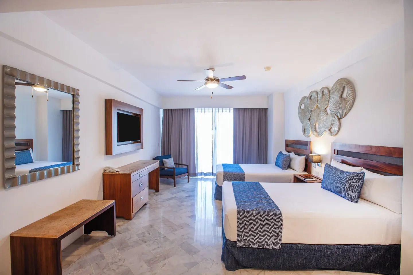 Superior Con Balcón room with two beds and curtained balcony doors at Vamar Vallarta Marina and Beach Resort.