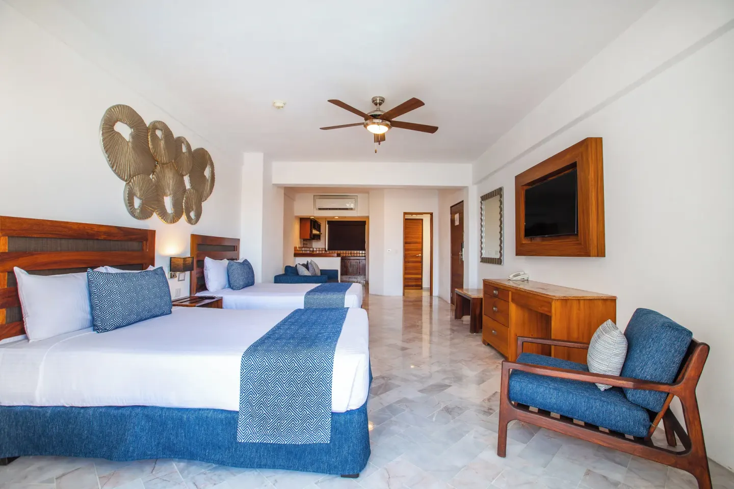 Superior Con Balcón room with two beds and kitchenette area at Vamar Vallarta Marina and Beach Resort.