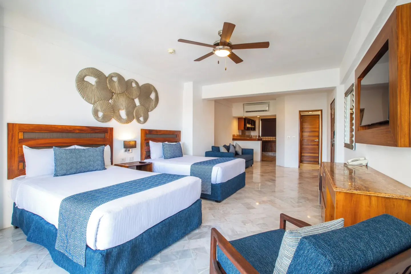 Superior Con Balcón room with two beds and sofa area at Vamar Vallarta Marina and Beach Resort.