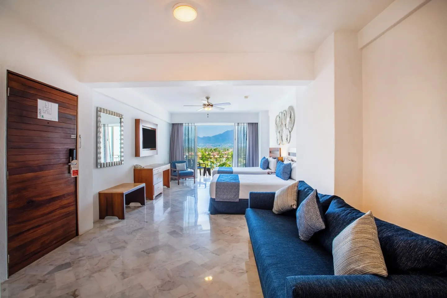 Superior Con Balcón room with two beds and sofa at Vamar Vallarta Marina and Beach Resort.