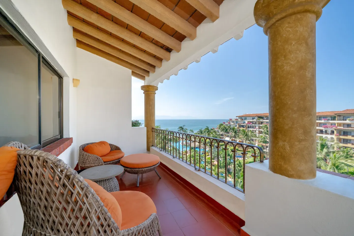Balcony seating with ocean and resort views at Velas Vallarta Suites Resort.