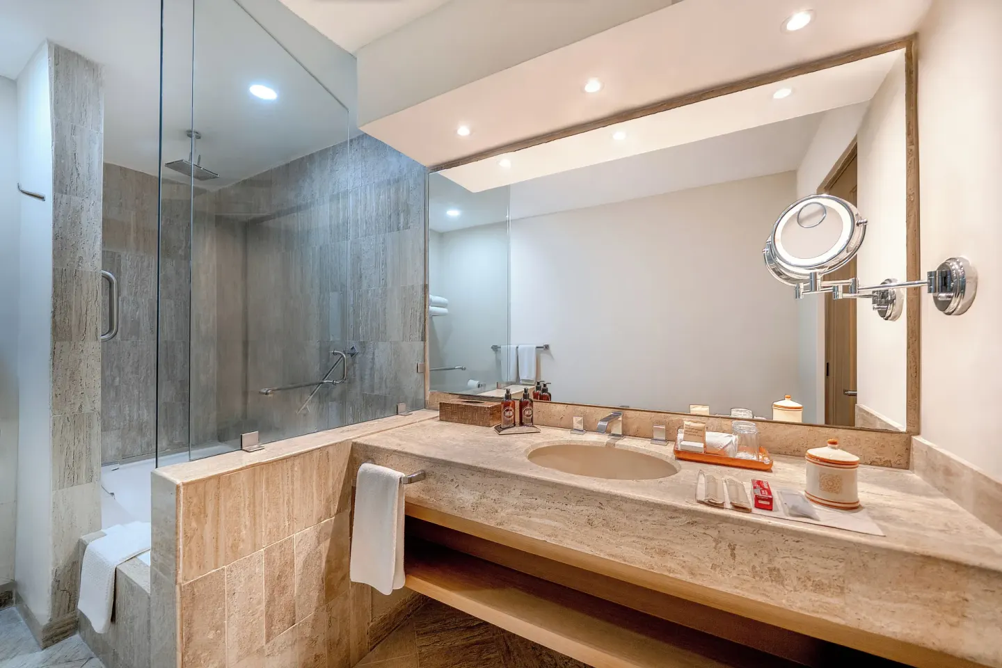 Bathroom vanity beside a glass tub-shower at Velas Vallarta Suites Resort.
