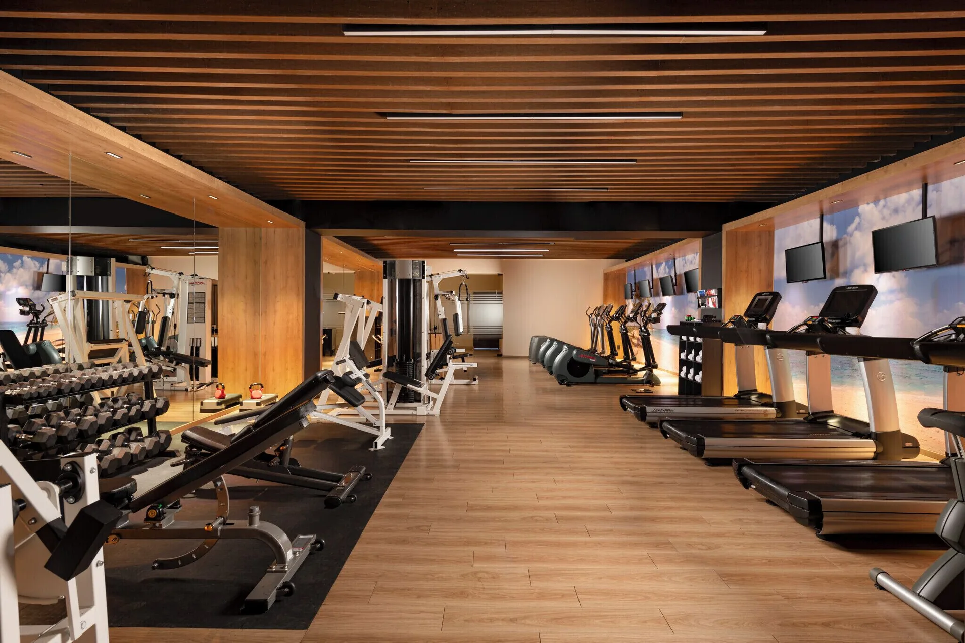 A fitness center with treadmills and weights at Velas Vallarta Suites Resort.