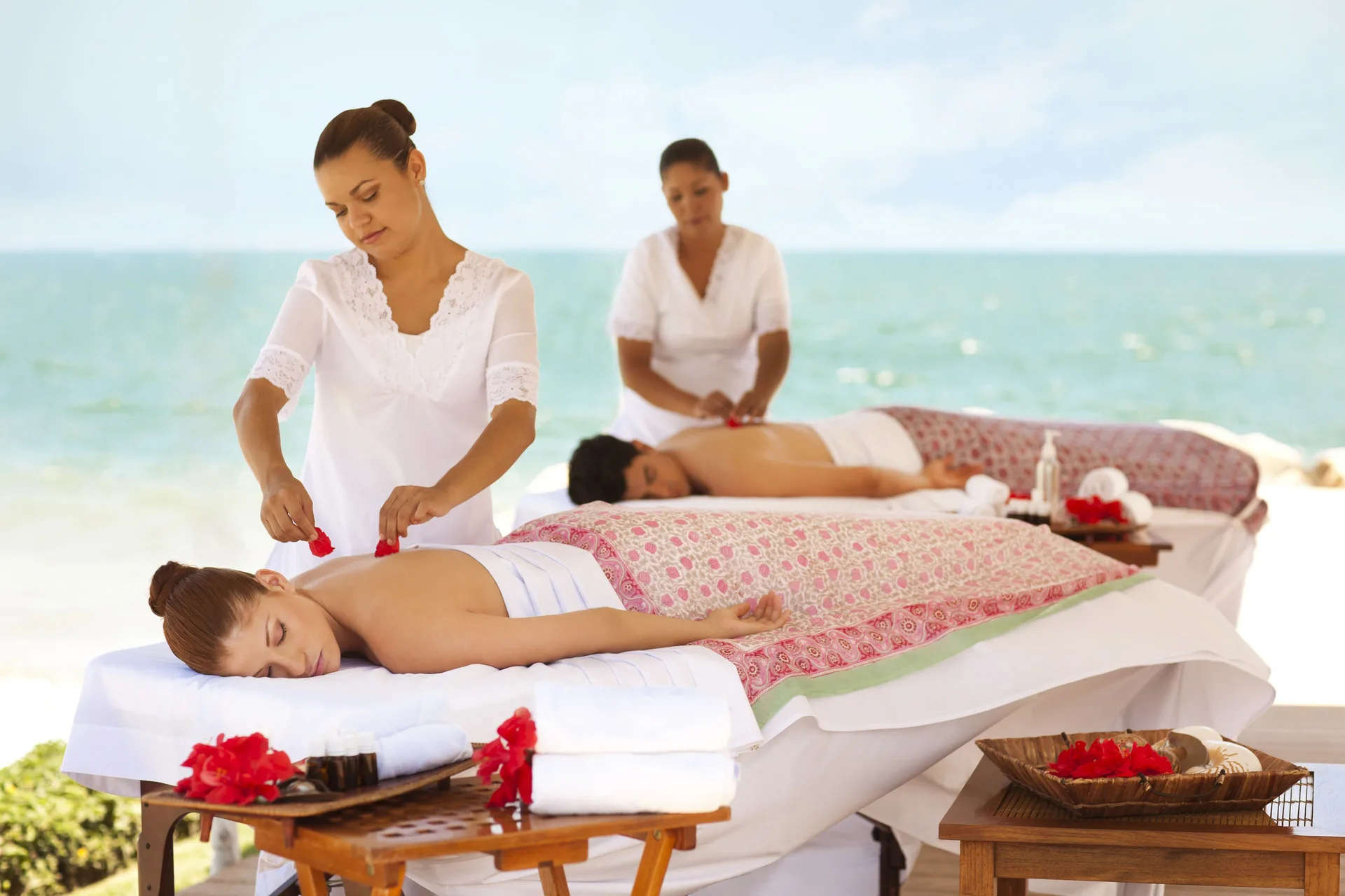 Two guests receive oceanfront massages at Velas Vallarta Suites Resort.