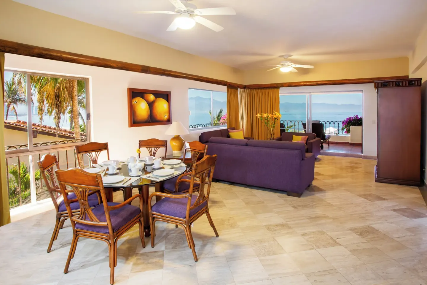 Suite dining and living area with balcony ocean views at Velas Vallarta Suites Resort.