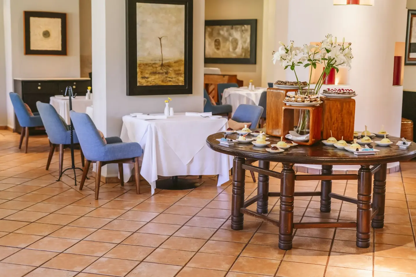 An indoor dining room with a dessert display at Velas Vallarta Suites Resort.