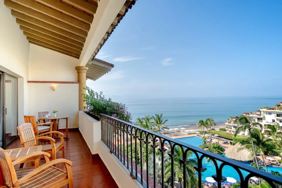 Deluxe Suite balcony with ocean and pool view at Velas Vallarta Suites Resort.