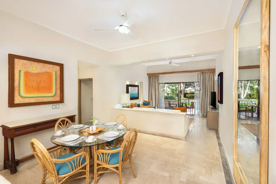 Deluxe Suite dining and living area with terrace beyond at Velas Vallarta Suites Resort.