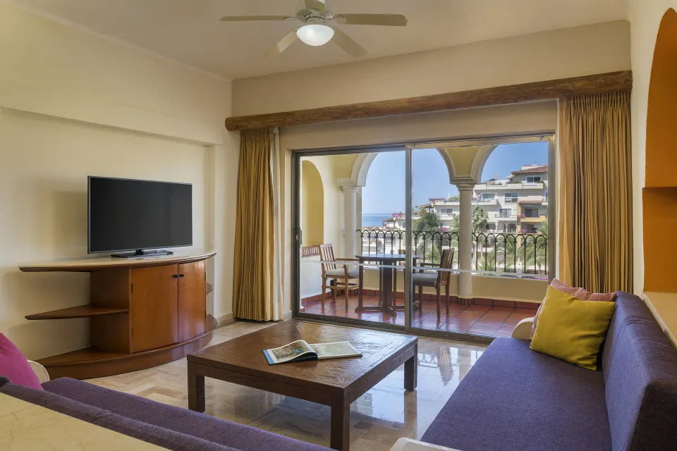 Family Suite living room with balcony seating at Velas Vallarta Suites Resort.