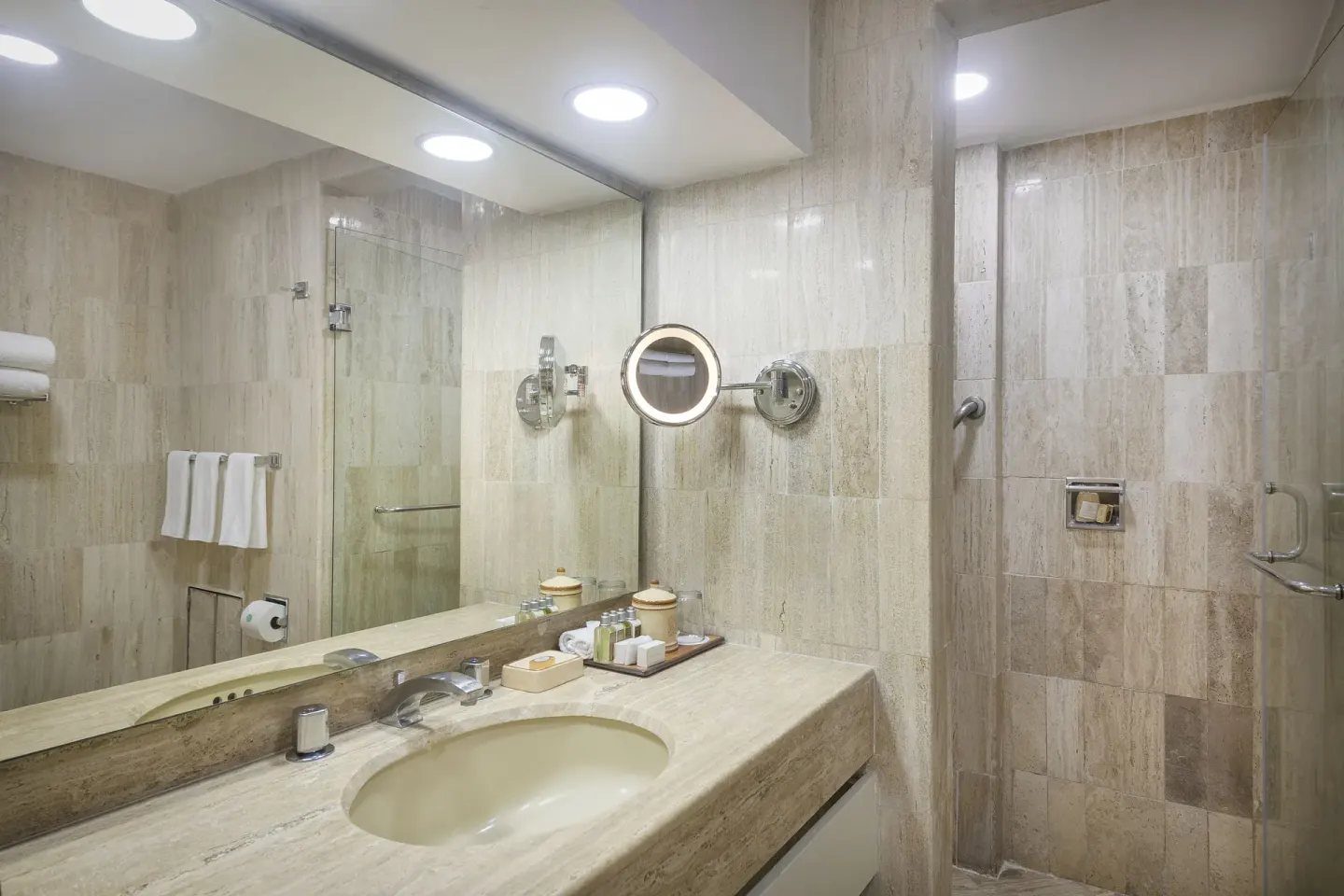 Suite bathroom vanity and glass shower at Velas Vallarta Suites Resort.