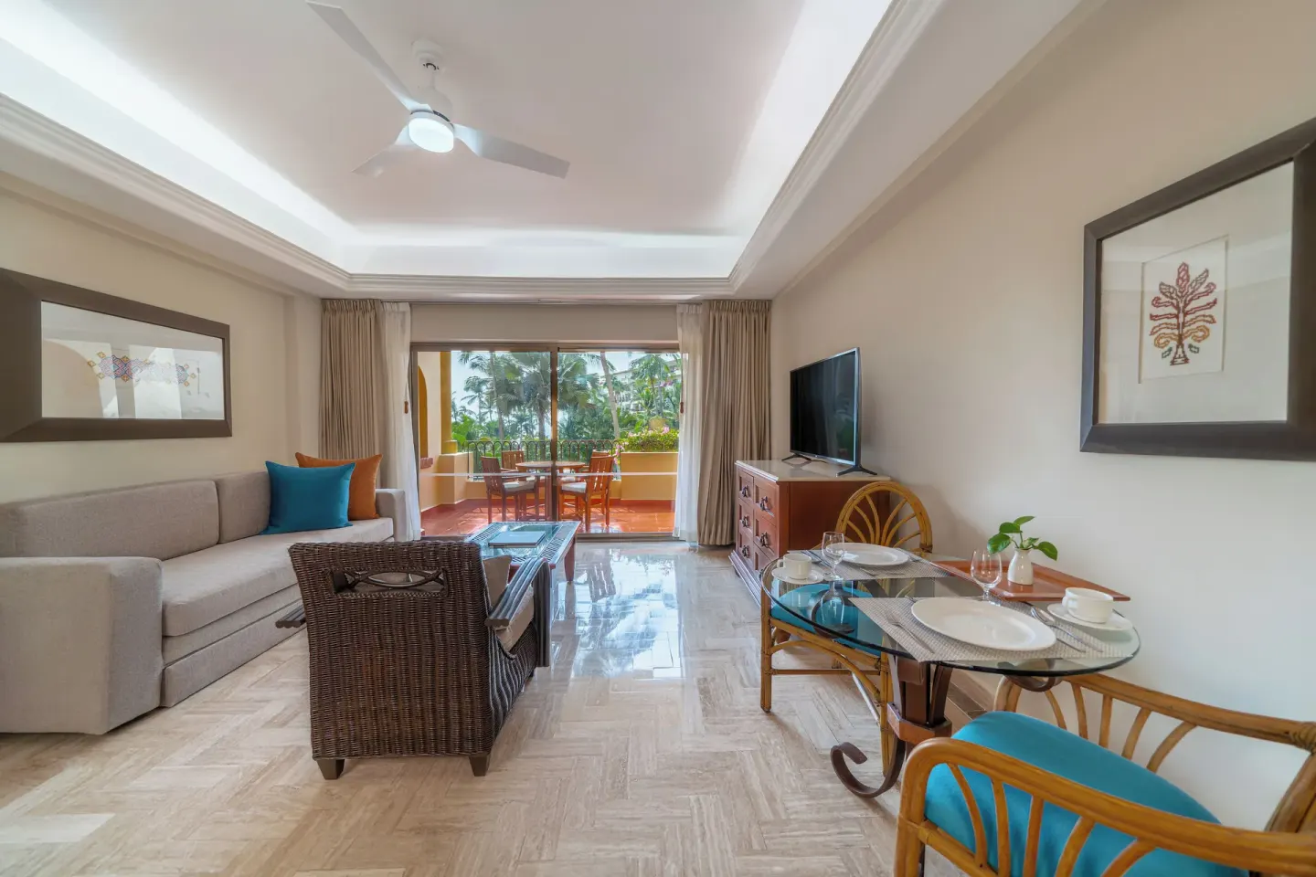 One Bedroom Suite living and dining area with balcony at Velas Vallarta Suites Resort.