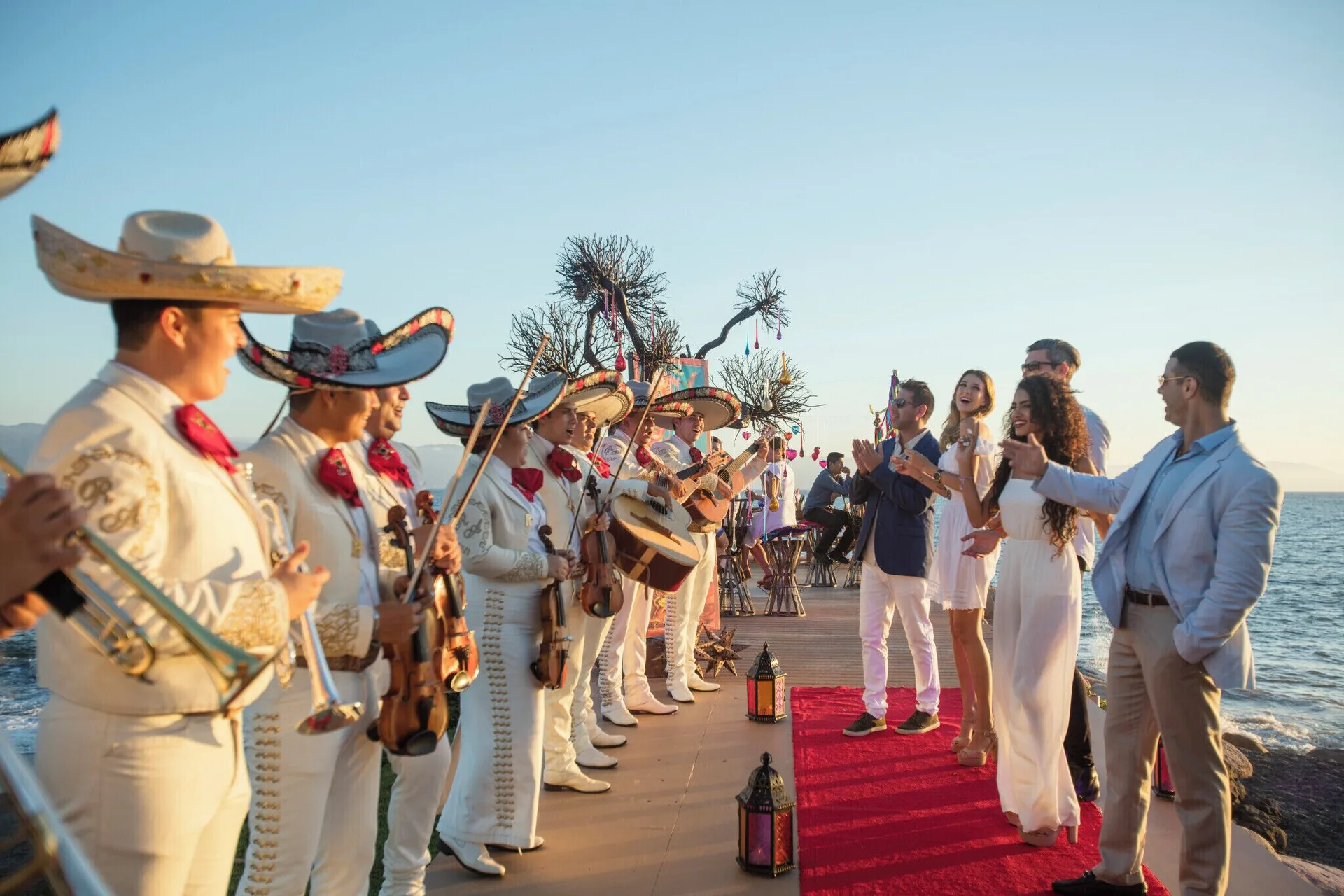 A mariachi band lines a seaside walkway for guests at Velas Vallarta Suites Resort.
