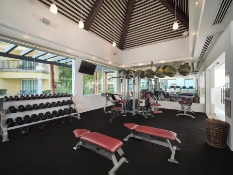 Weight benches and free weights fill the fitness room at Ventus at Marina El Cid Spa & Beach Resort.