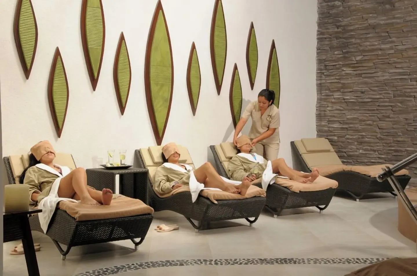 Spa lounge chairs with guests in robes at Ventus at Marina El Cid Spa & Beach Resort.