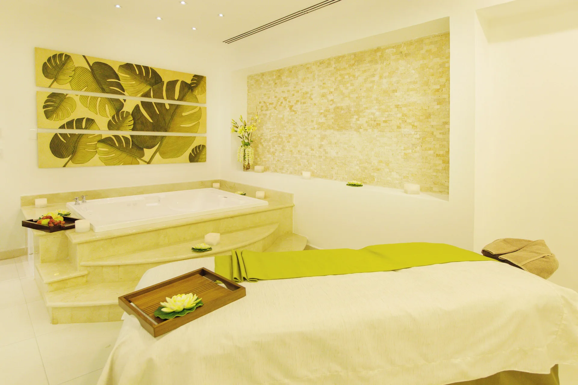 Spa treatment room with massage table and soaking tub at Ventus at Marina El Cid Spa & Beach Resort.