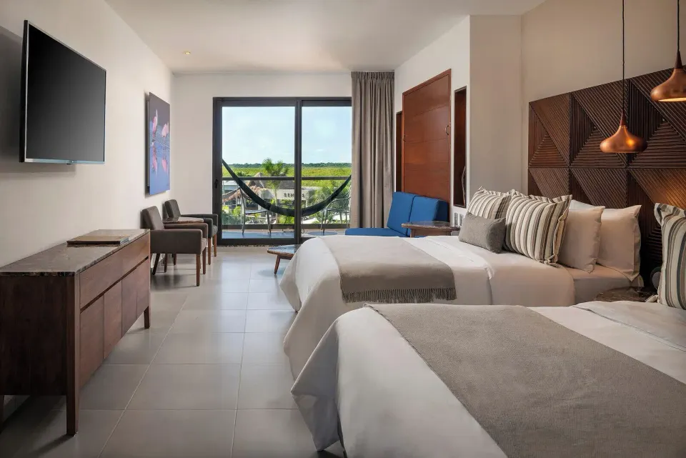 Family Room with two beds and balcony hammock at Ventus at Marina El Cid Spa & Beach Resort.