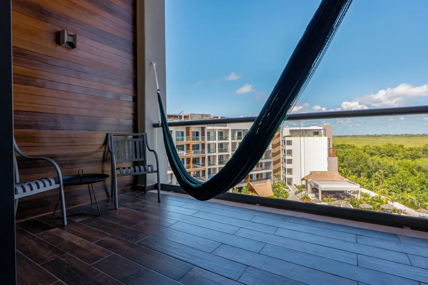 Junior Suite balcony with hammock and resort view at Ventus at Marina El Cid Spa & Beach Resort.