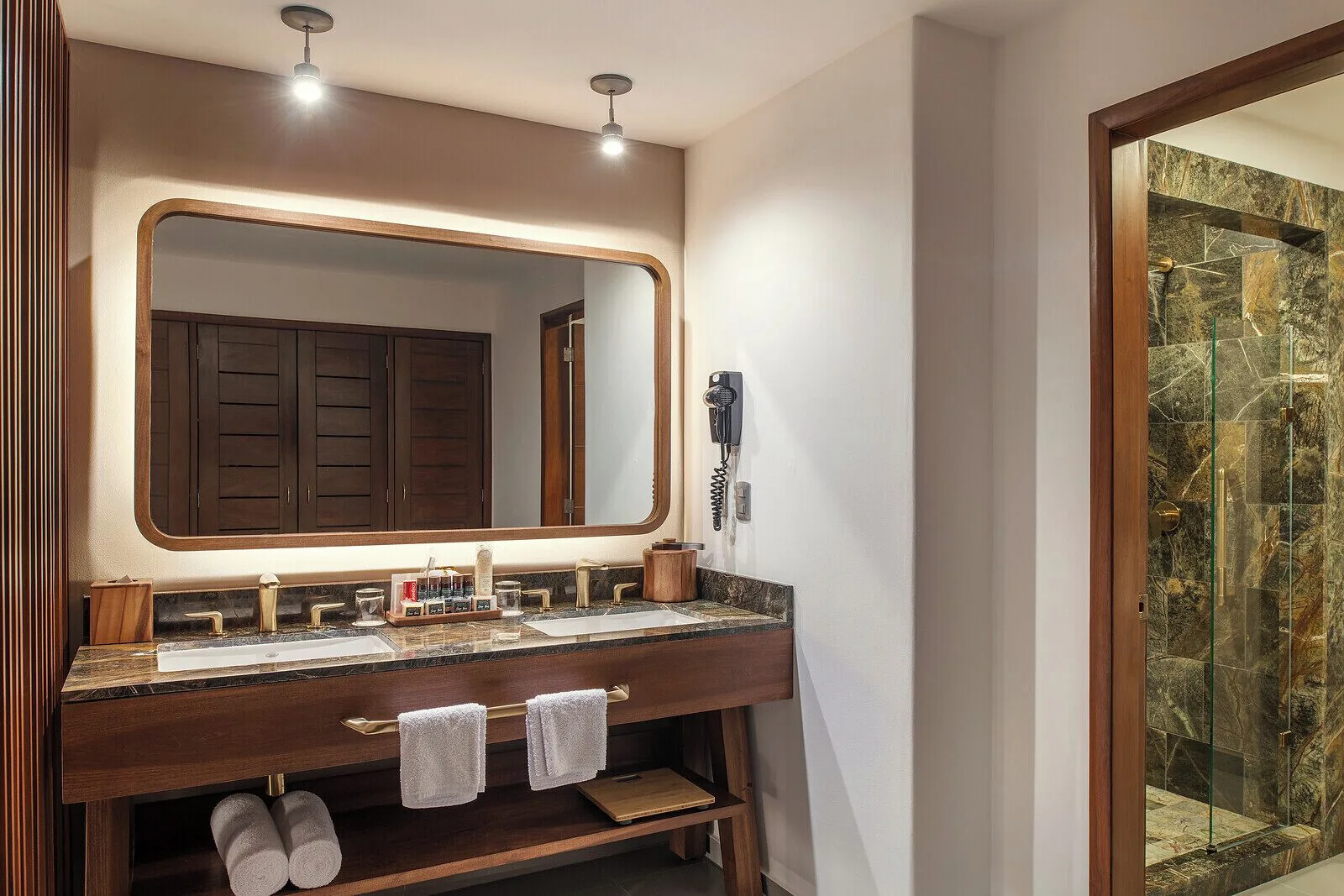 Junior Suite bathroom vanity and shower at Ventus at Marina El Cid Spa & Beach Resort.
