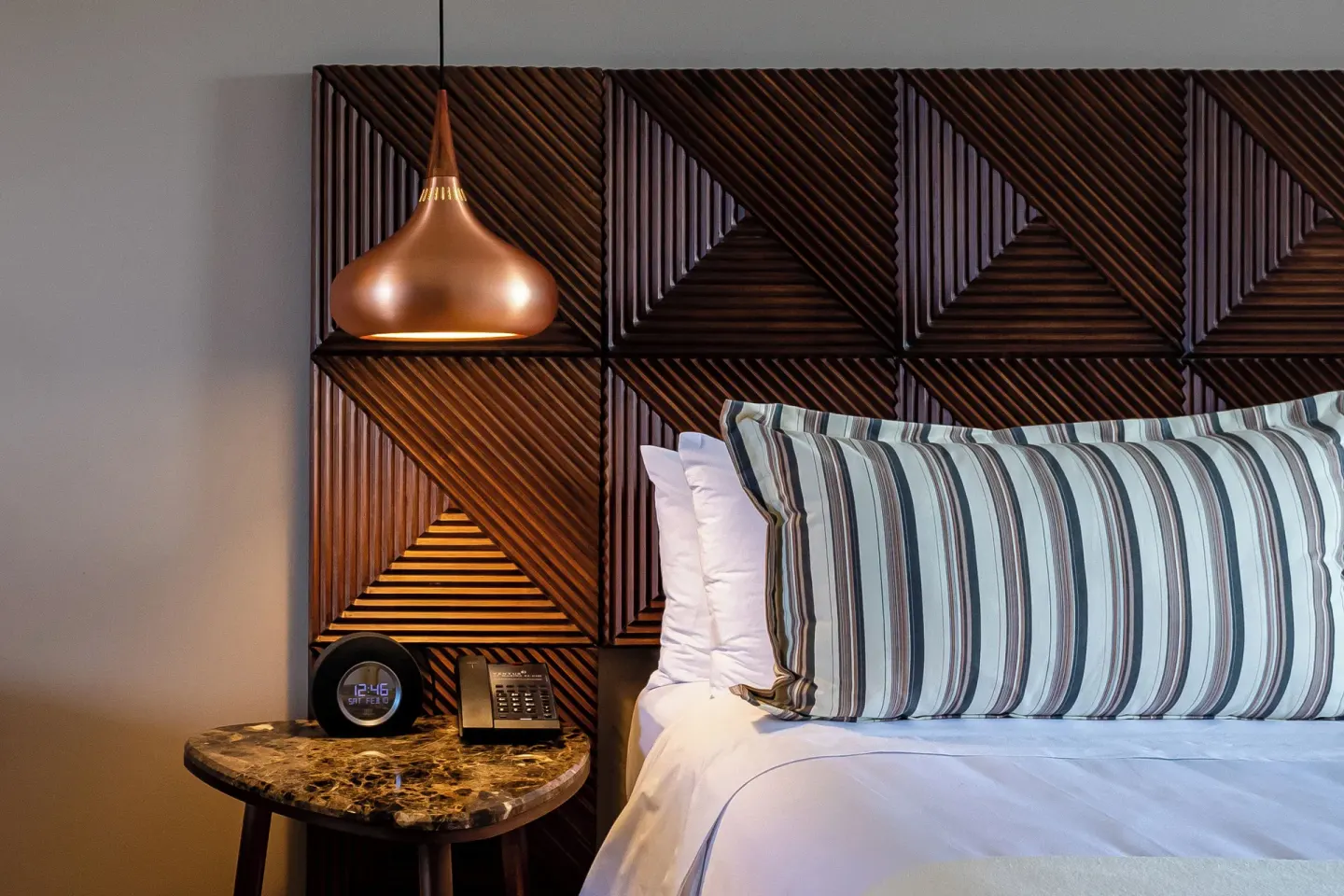 Junior Suite king bed detail with side table at Ventus at Marina El Cid Spa & Beach Resort.