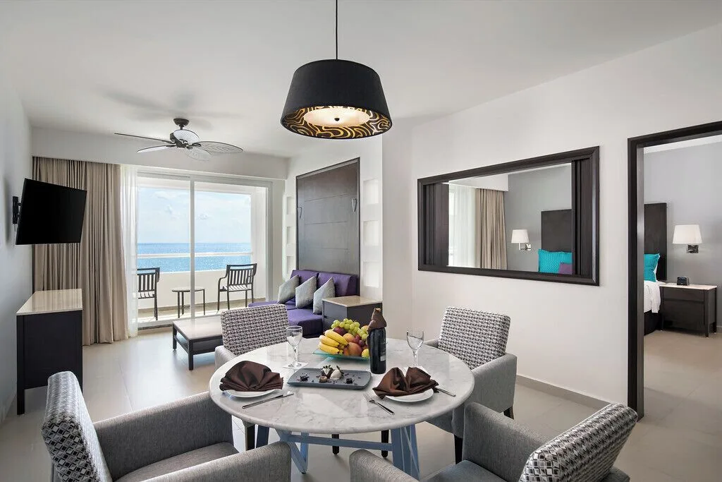 One Bedroom Suite Platinum dining and lounge area at Ventus at Marina El Cid Spa & Beach Resort.