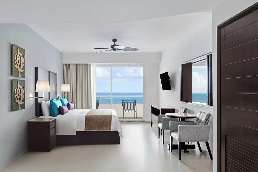 One Bedroom Suite Platinum king bed and balcony view at Ventus at Marina El Cid Spa & Beach Resort.