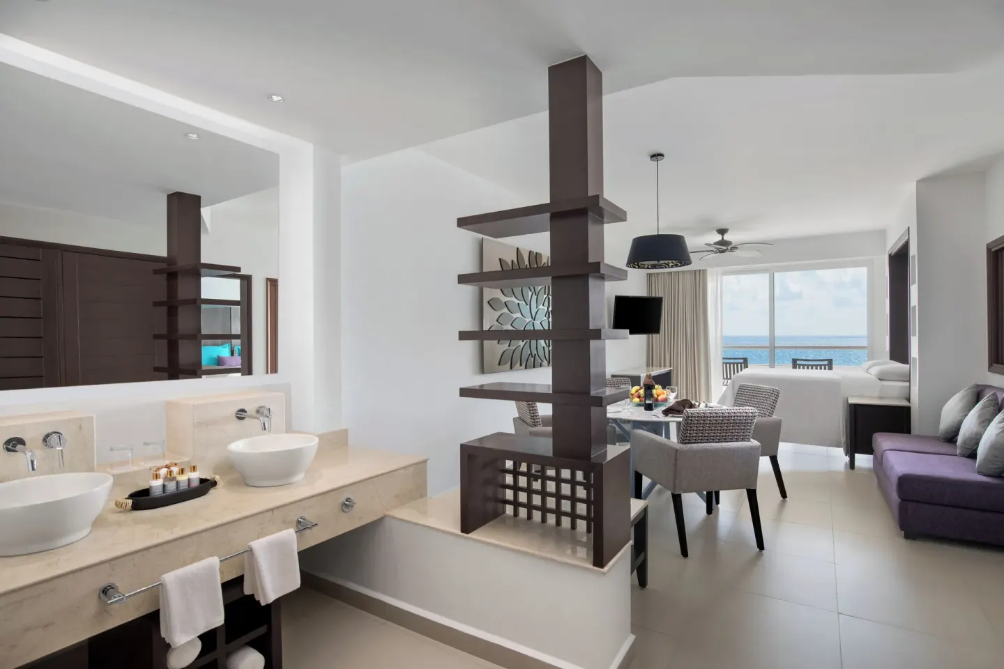 One Bedroom Suite Platinum vanity and living area at Ventus at Marina El Cid Spa & Beach Resort.
