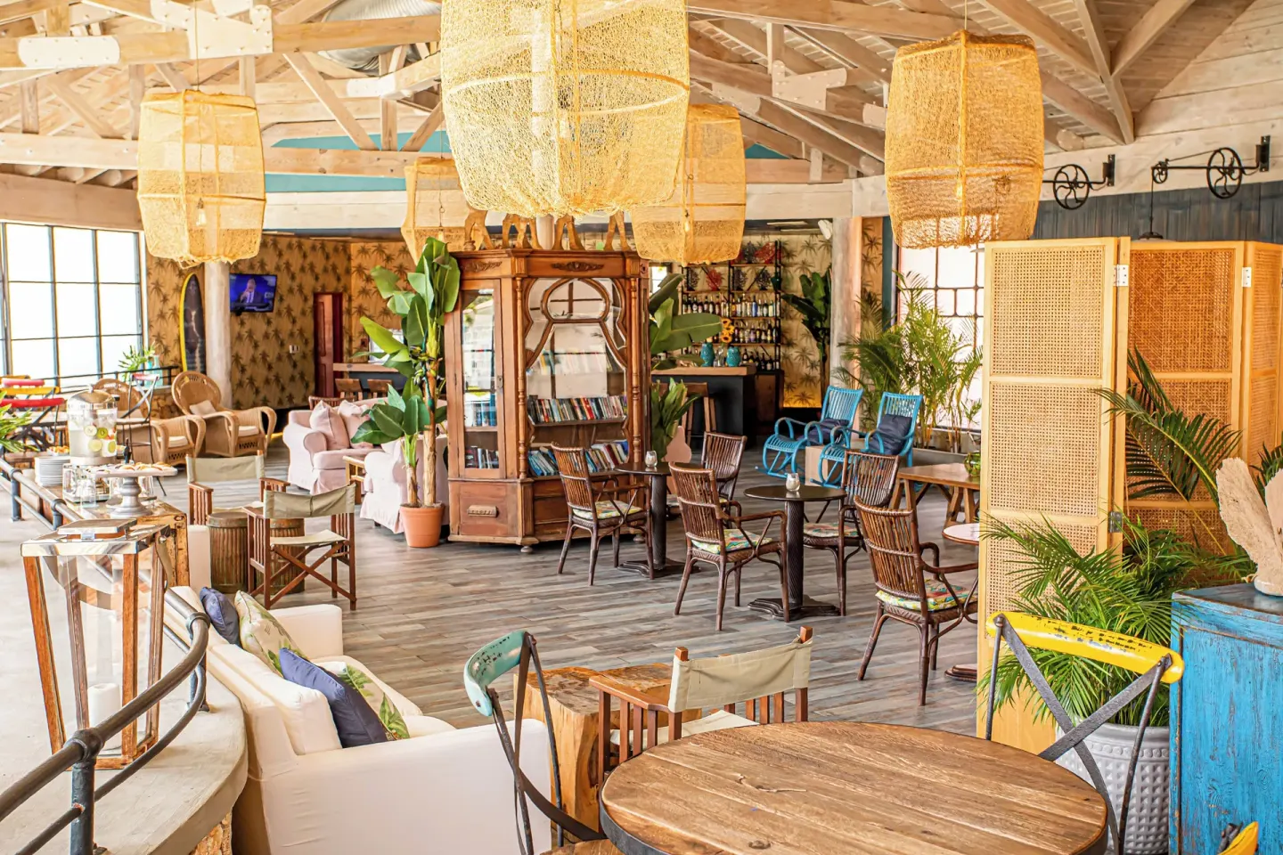 Colorful lounge seating with wicker chairs and pendant lights at VH Gran Ventana Beach Resort.