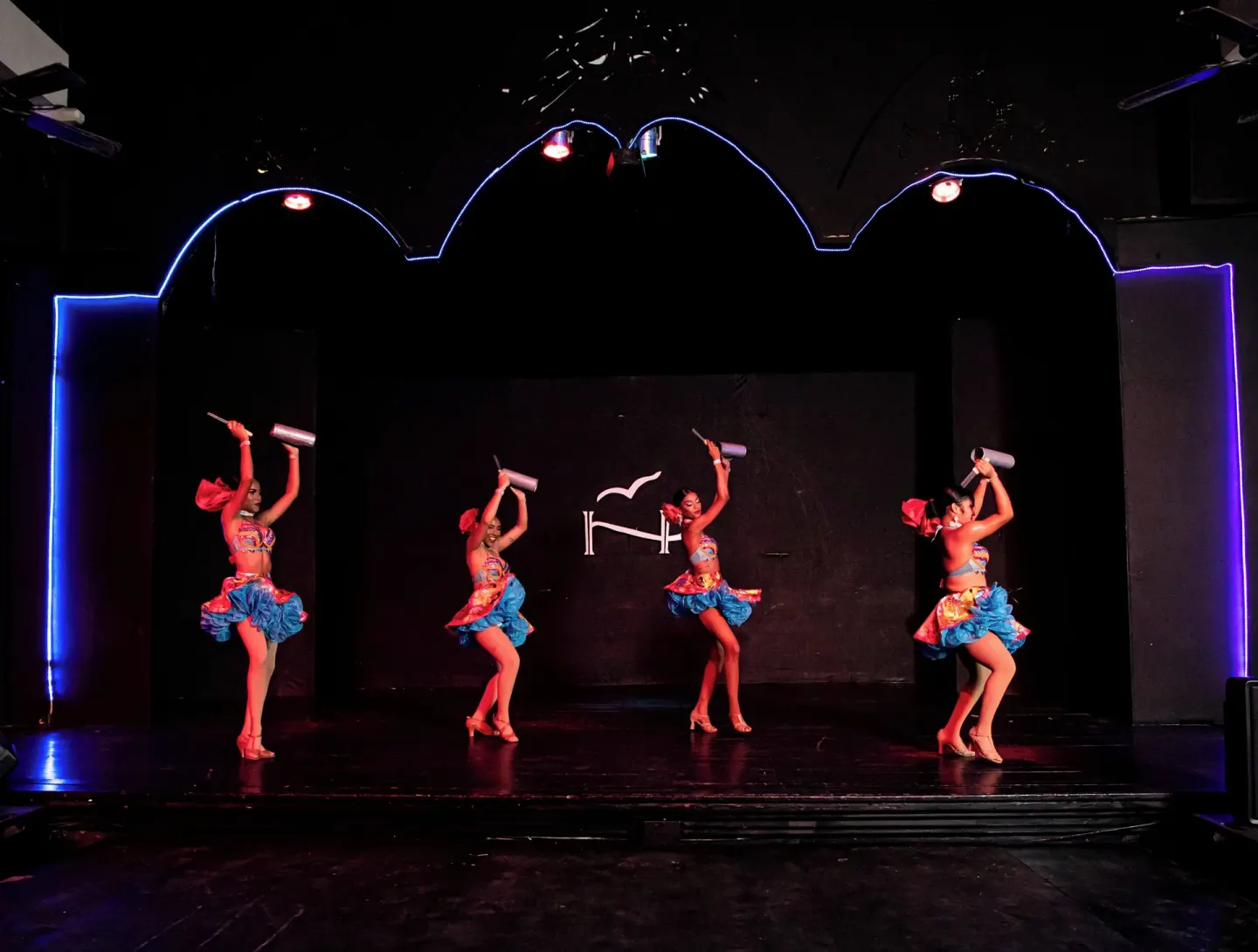 Dancers with handheld props on a lit stage at VH Gran Ventana Beach Resort.